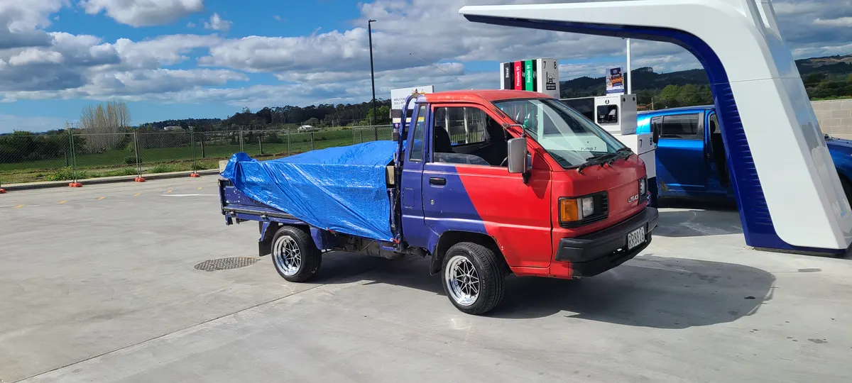 Jay's truck loaded with garden rubbish under a tarp